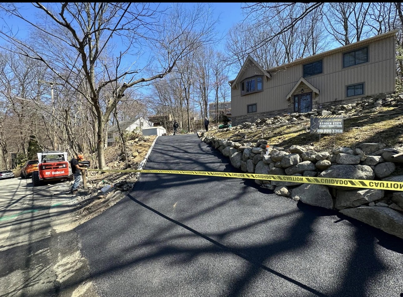 New asphalt driveway up a wooded hillside in NJ