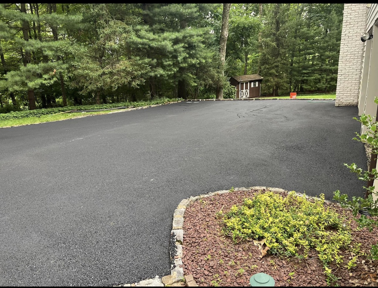 Smooth wide residential driveway with landscaping