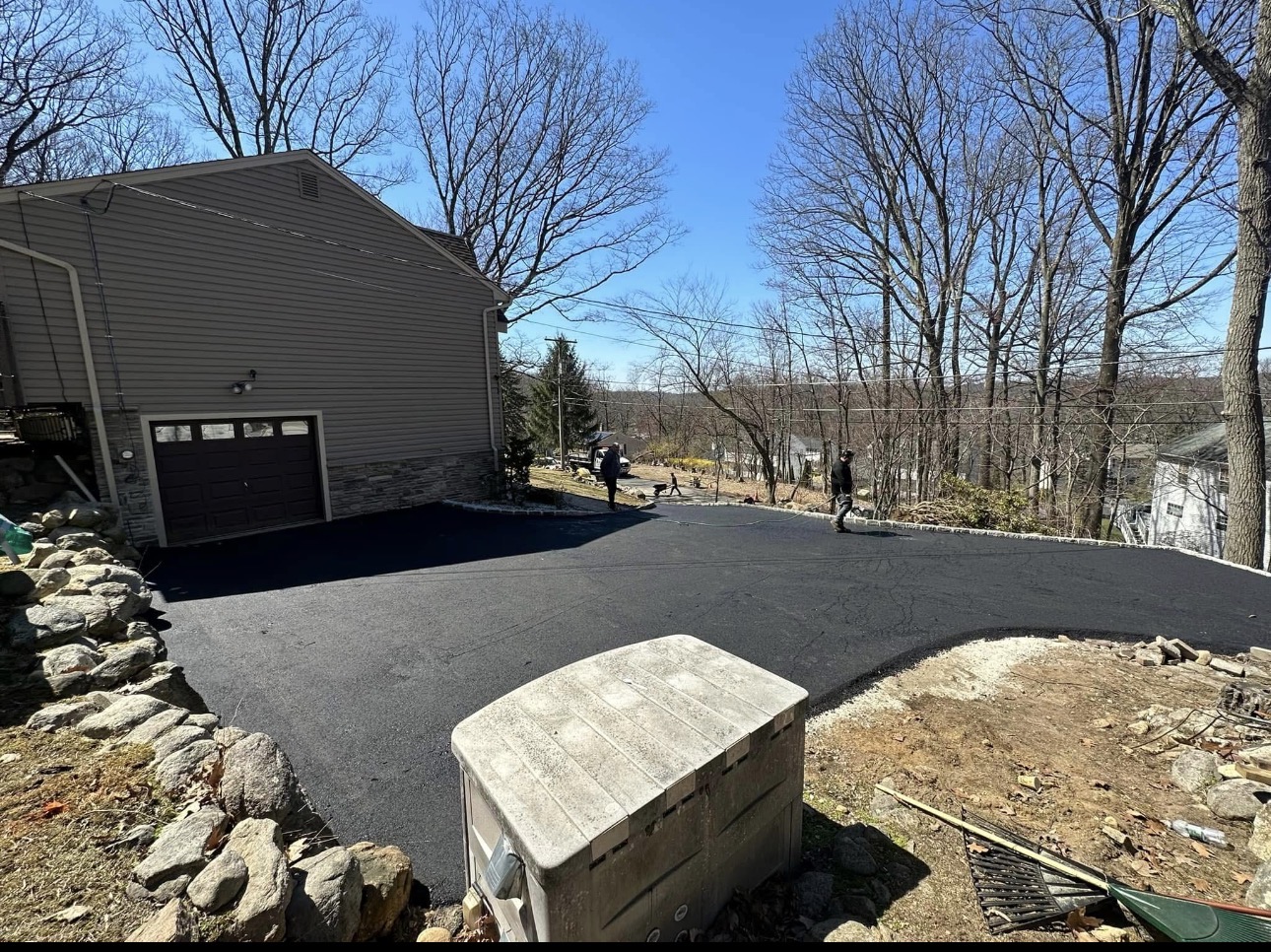 Completed asphalt driveway at hillside garage in NJ